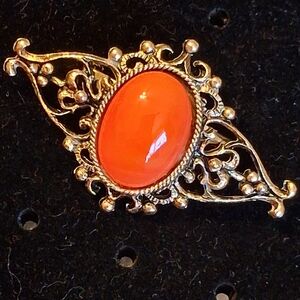 Elegant Goldtone Filigree Brooch With Coral Colored Cabochon Stone